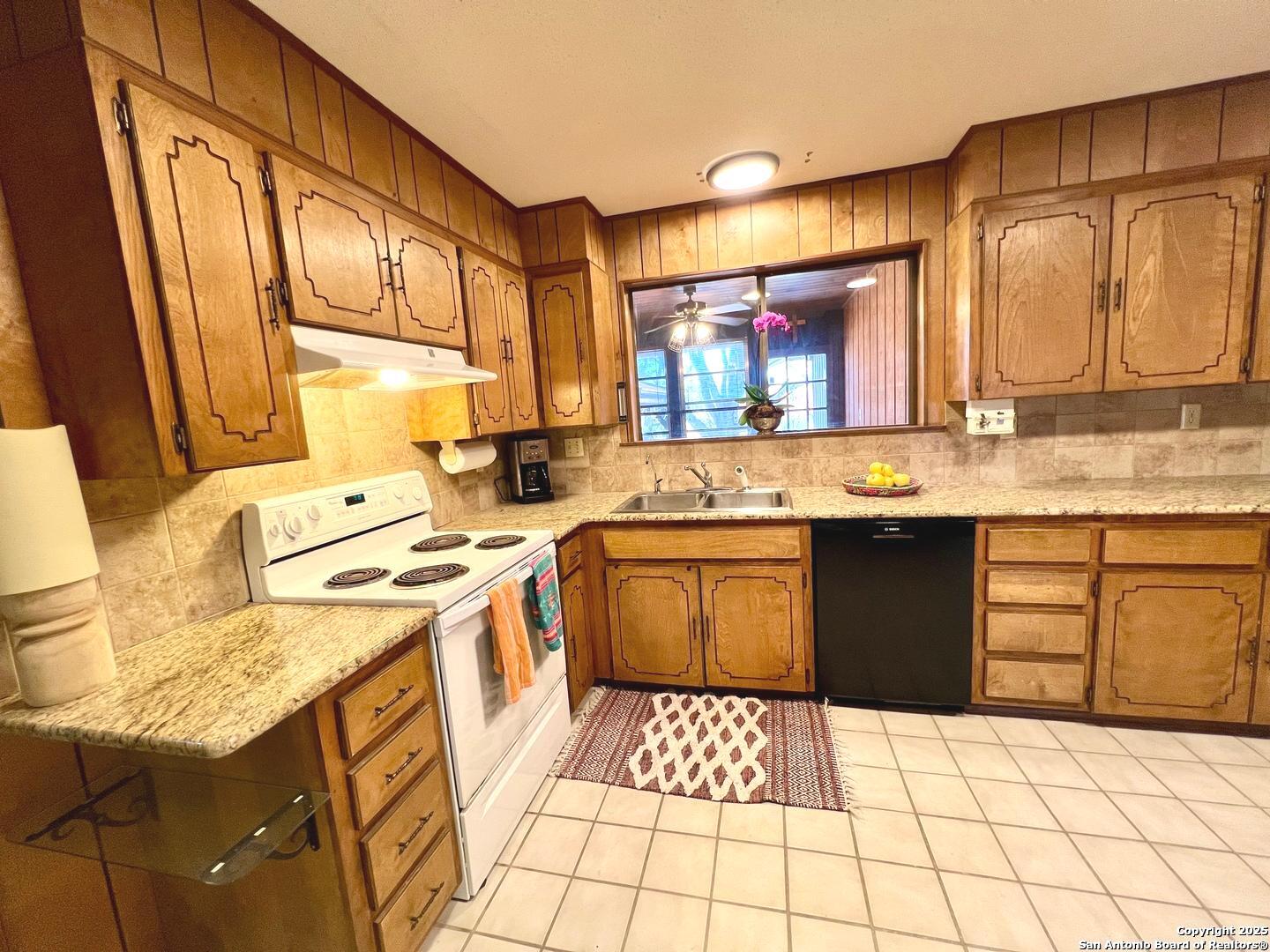 433 Fort Clark Road Brackettville, TX 78832 - Photo 14 of 46 a kitchen with a sink stove and cabinets