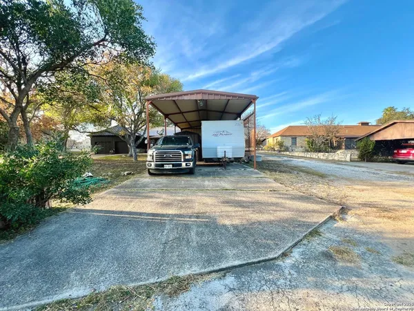 a view of a yard with a house in the background