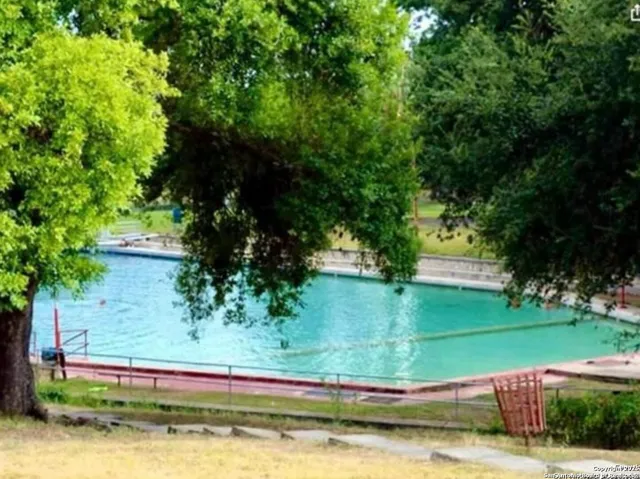 a large room with a large window and chandelier