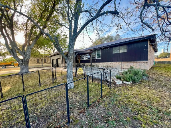 a view of a house with garden and trees