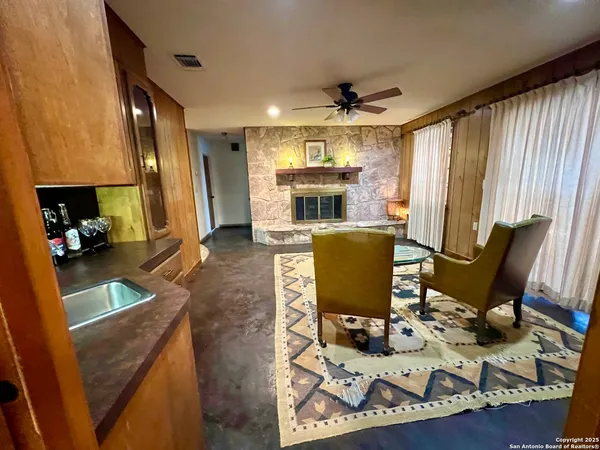 a view of a workspace with furniture and a kitchen