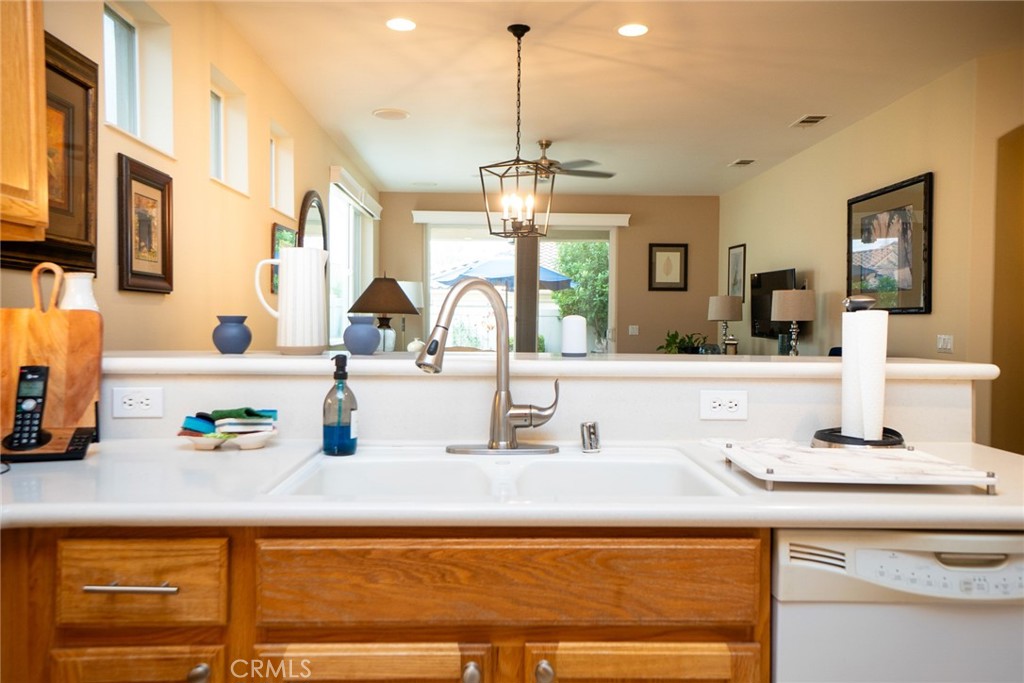 1165 Wisteria Way Beaumont, CA 92223 - Photo 20 of 49 a kitchen with a sink and a chandelier