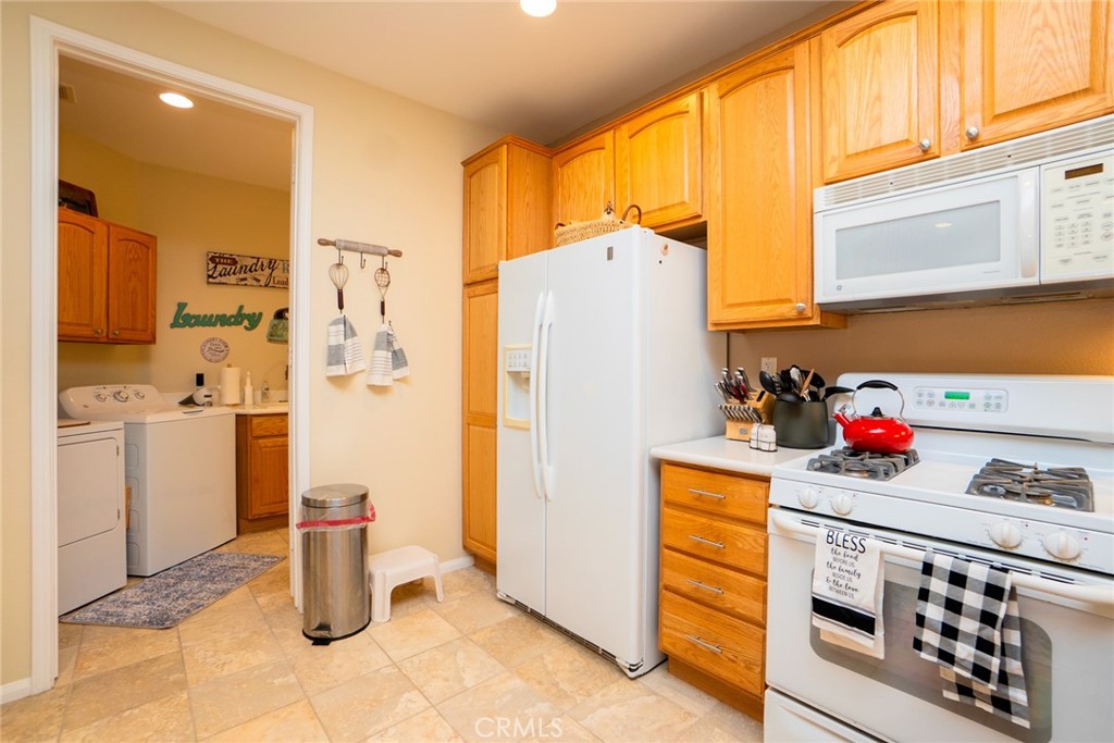 1165 Wisteria Way Beaumont, CA 92223 - Photo 22 of 49 a kitchen with stainless steel appliances a refrigerator sink and cabinets