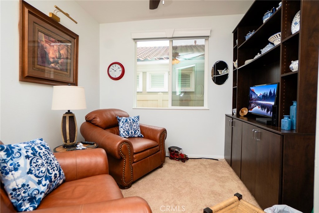 1165 Wisteria Way Beaumont, CA 92223 - Photo 26 of 49 a living room with furniture and a flat screen tv