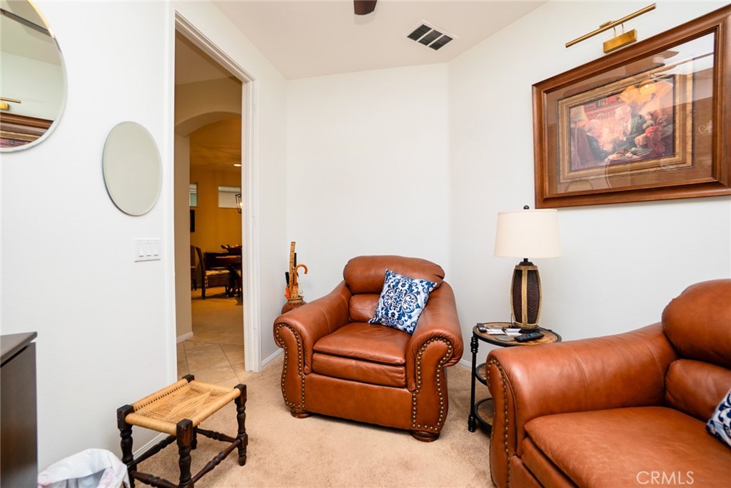 1165 Wisteria Way Beaumont, CA 92223 - Photo 28 of 49 a blue couch sitting in a living room next to a bathroom