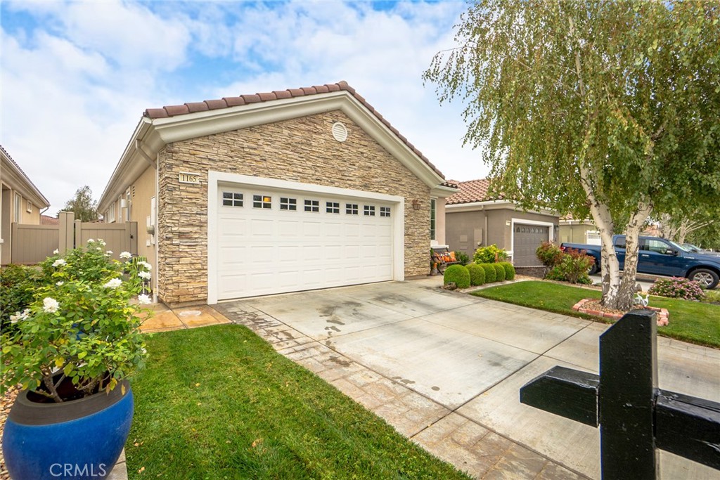 1165 Wisteria Way Beaumont, CA 92223 - Photo 3 of 49 a view of a house with a yard