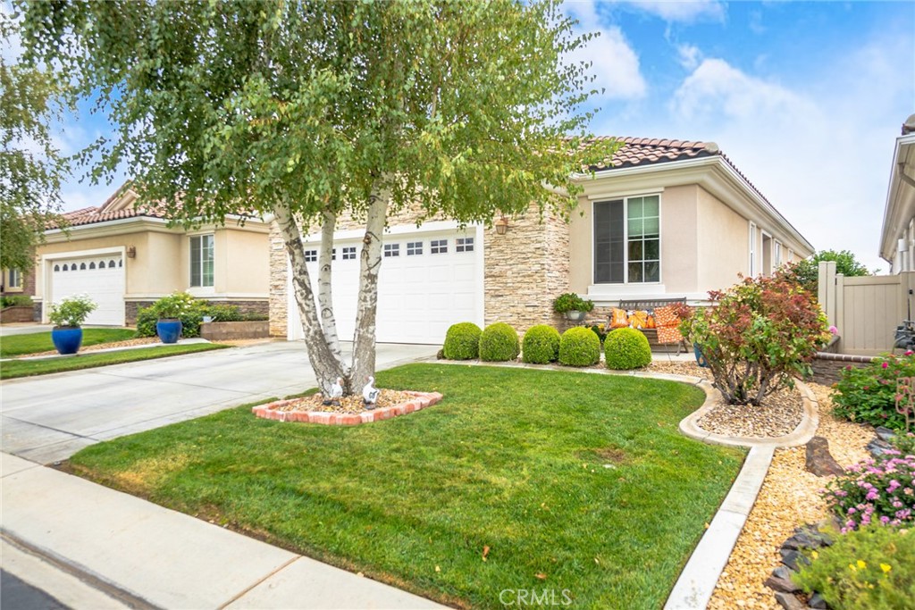 1165 Wisteria Way Beaumont, CA 92223 - Photo 5 of 49 a front view of a house with garden