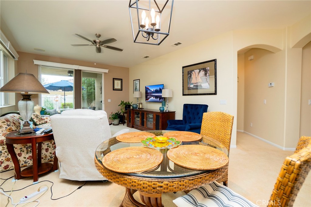1165 Wisteria Way Beaumont, CA 92223 - Photo 10 of 49 a living room with patio chairs and a chandelier