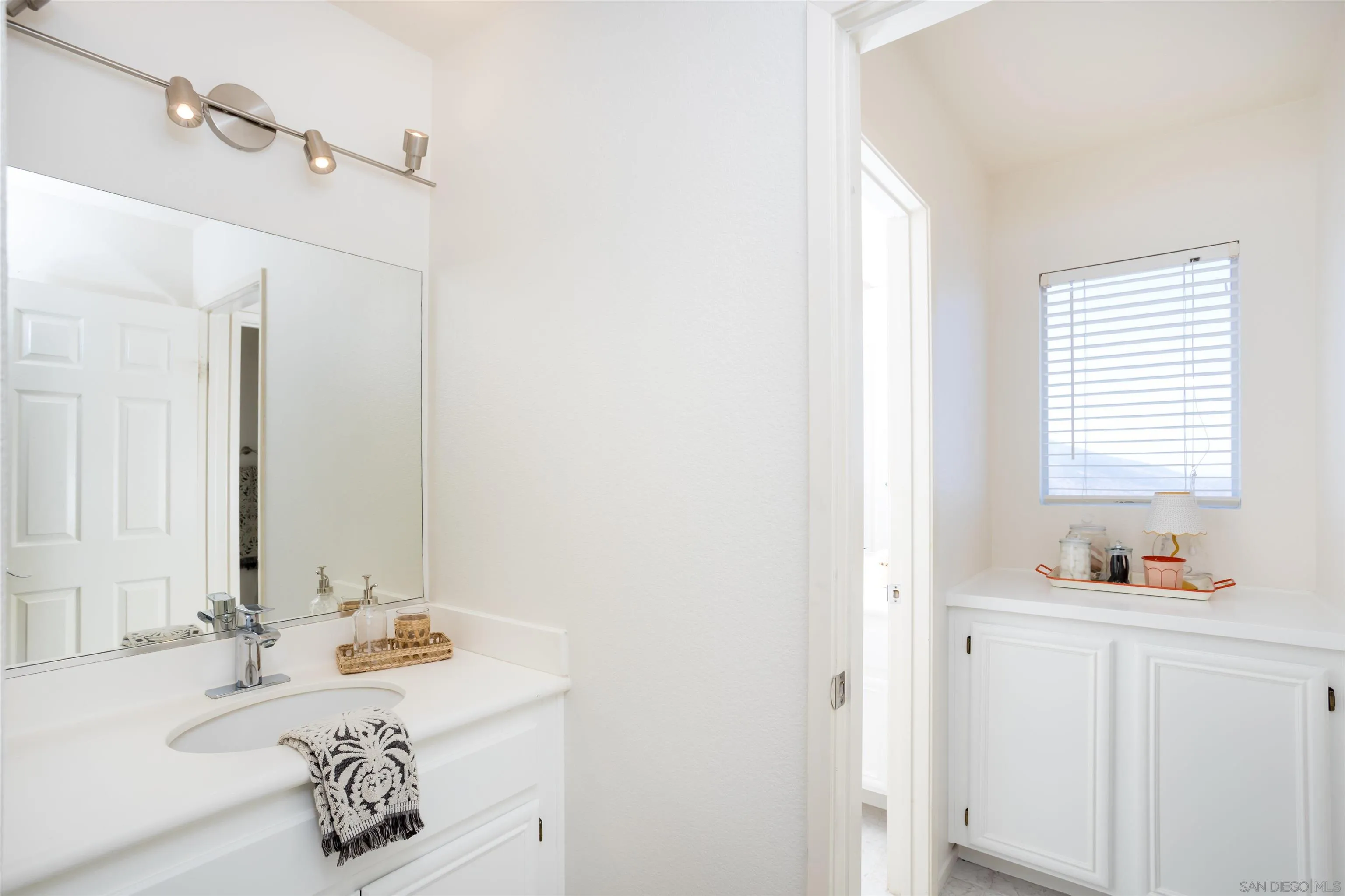2168 Pointe Parkway Spring Valley, CA 91978 - Photo 25 of 50 a bathroom with a sink and a mirror