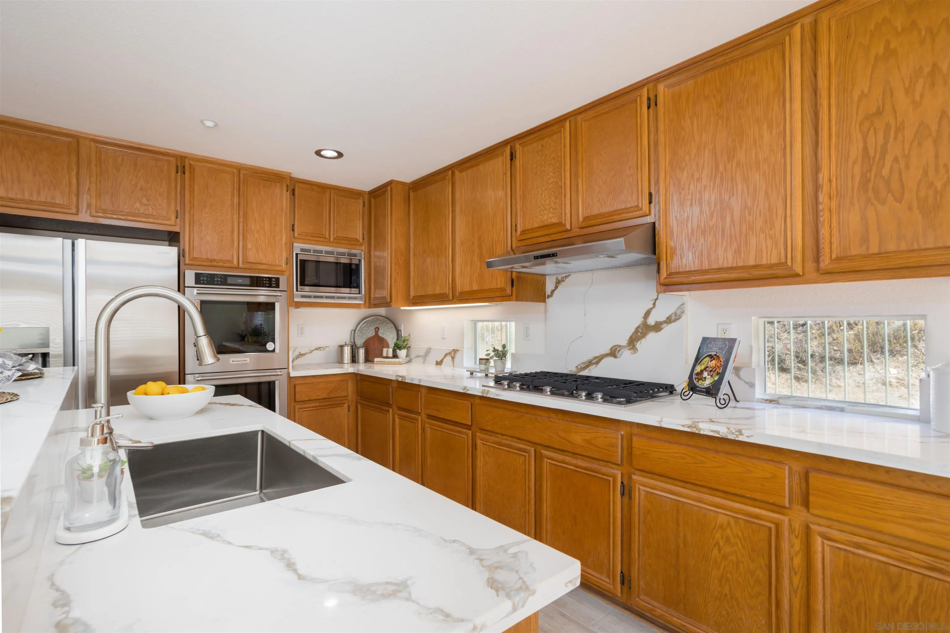 2168 Pointe Parkway Spring Valley, CA 91978 - Photo 4 of 50 a kitchen with granite countertop a sink a stove and cabinets