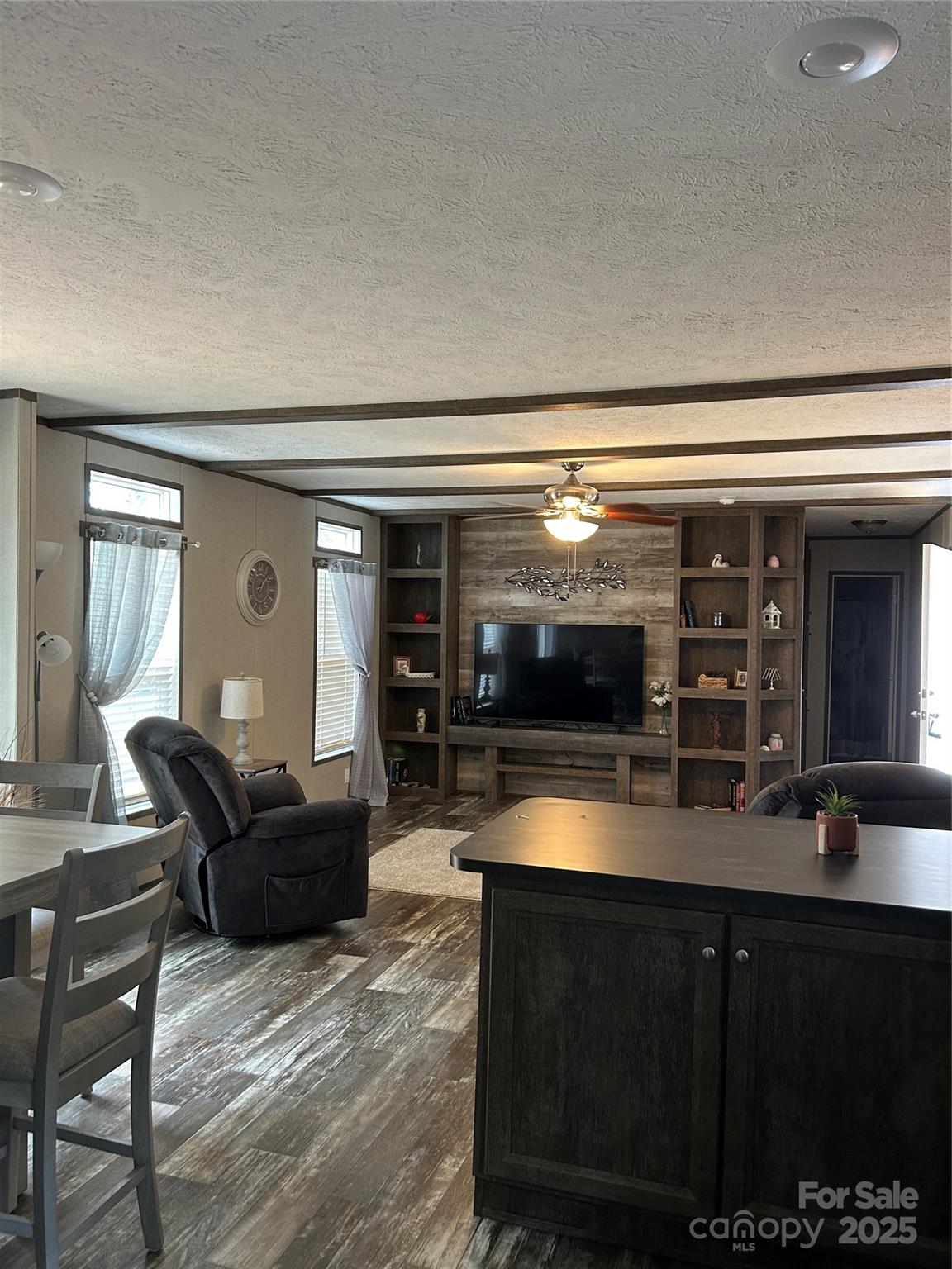 365 Rock Road Rutherfordton, NC 28139 - Photo 14 of 31 a living room with furniture a flat screen tv and kitchen view