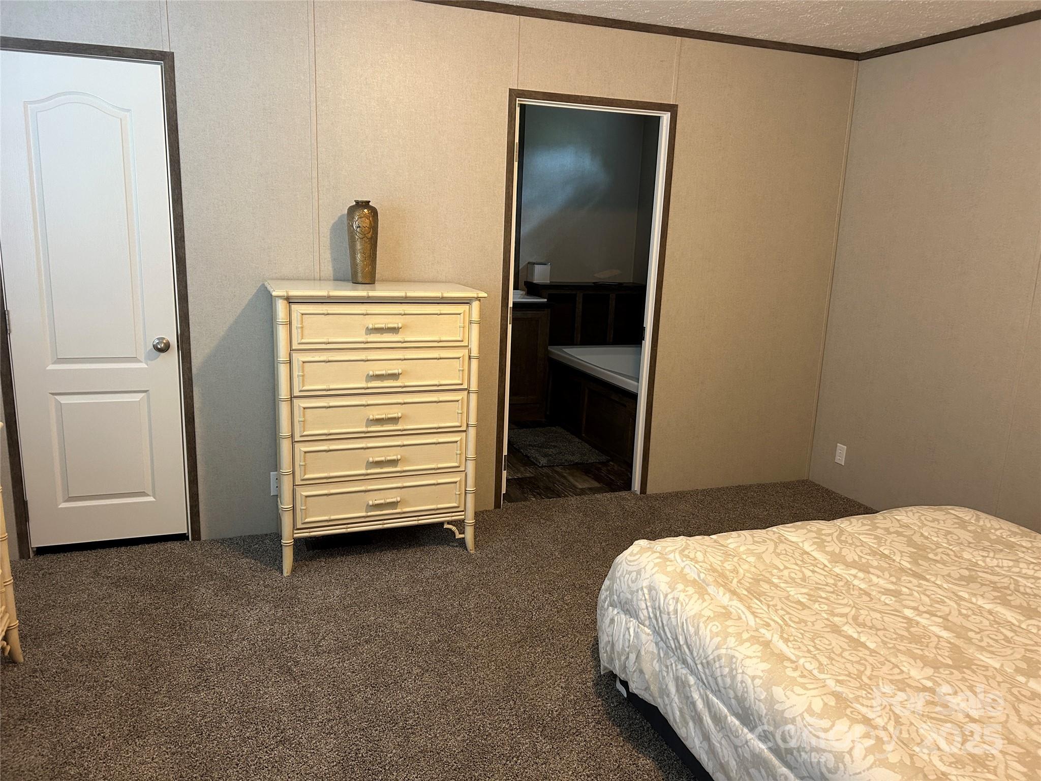 365 Rock Road Rutherfordton, NC 28139 - Photo 30 of 31 a bedroom with a bed and a walk in closet