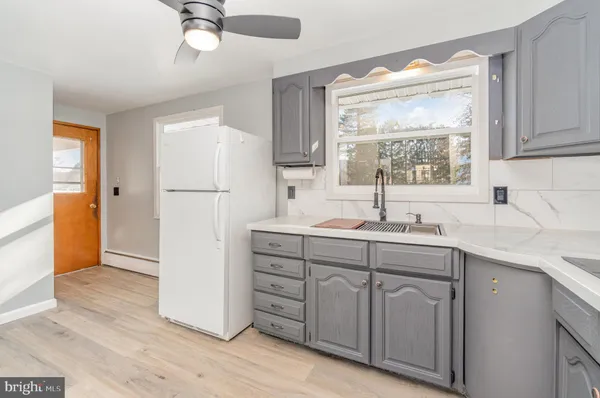 a kitchen with a sink appliances and cabinets