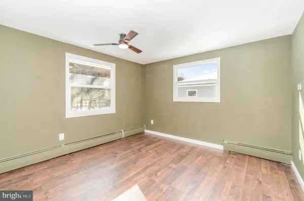 a view of a room with wooden floor