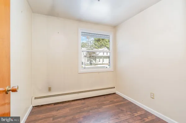 a view of hallway with wooden floor