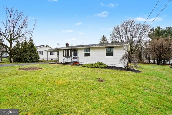 a front view of house with yard and trees