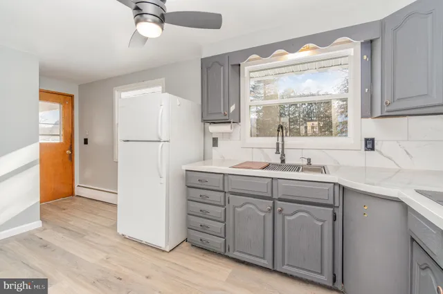 a kitchen with a sink appliances and cabinets