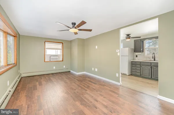 a view of a kitchen with an empty room and window