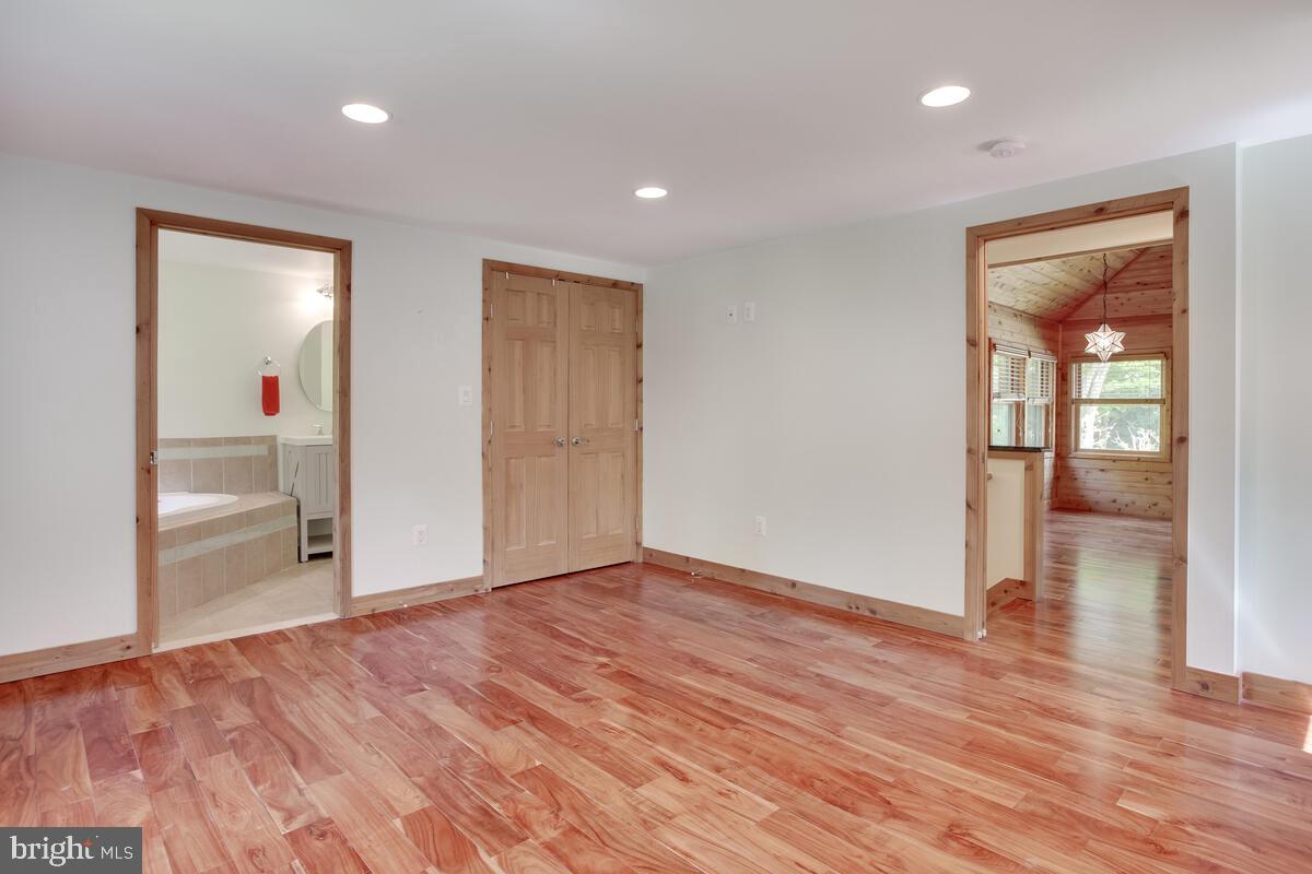 2359 Acacia Road Port Republic, MD 20676 - Photo 23 of 69 a view of an empty room with wooden floor and a bathroom