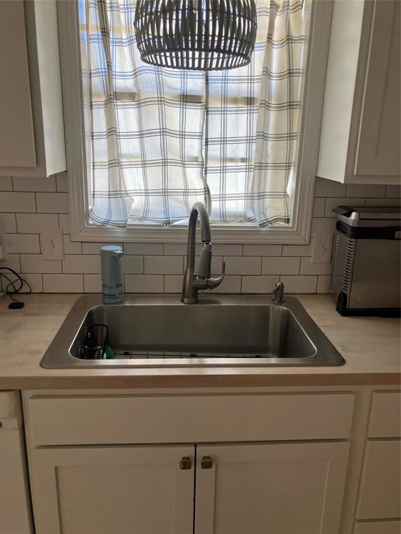 233 Church Road Stonewall, LA 71078 - Photo 28 of 32 Kitchen view of white cabinets, light countertops, and decorative backsplash