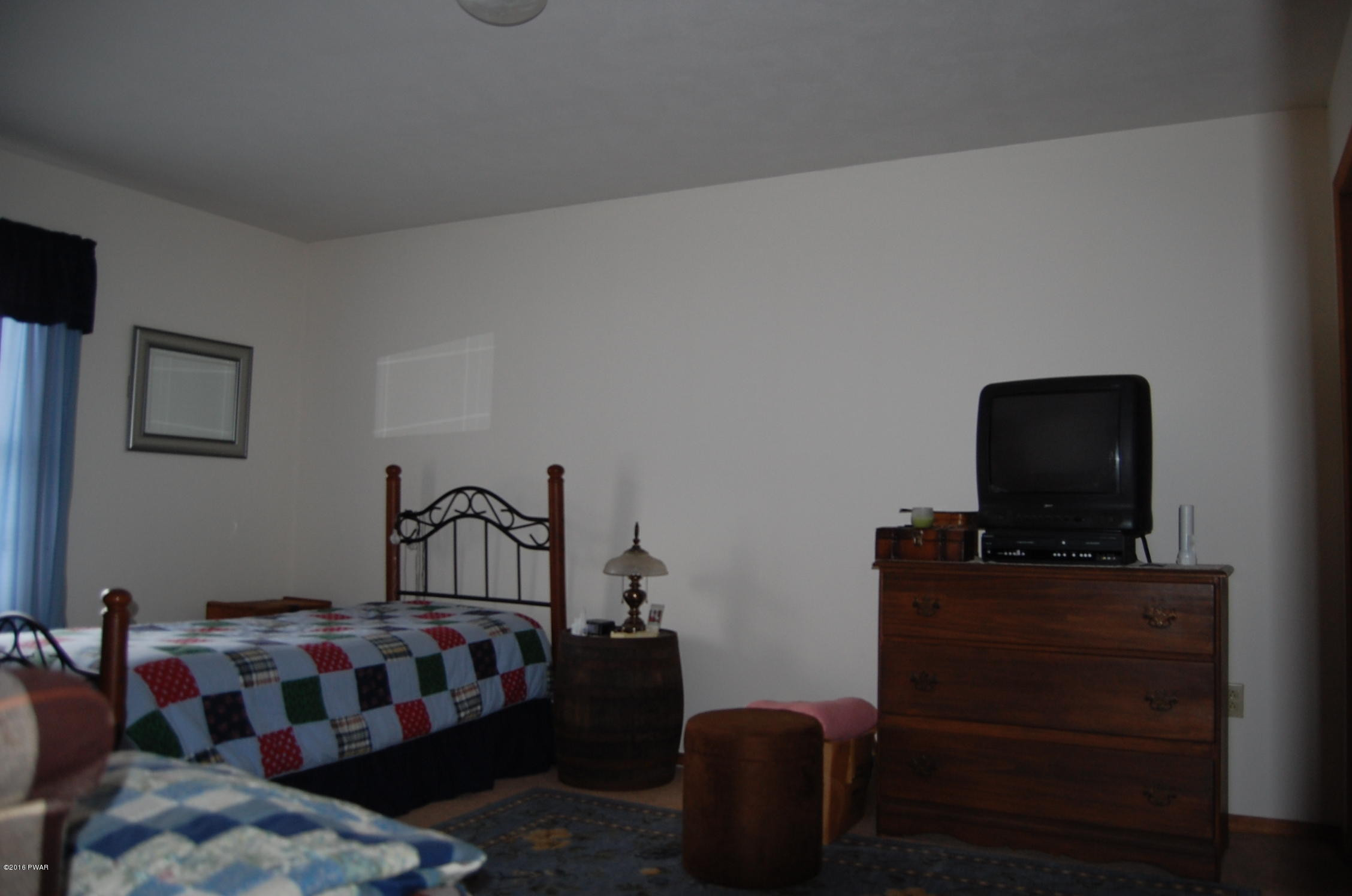 215 Maple Ridge Drive Hawley, PA 18428 - Photo 13 of 14 a bedroom with furniture and a window