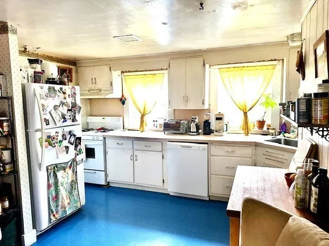 a kitchen with stainless steel appliances a stove a sink a refrigerator and cabinets