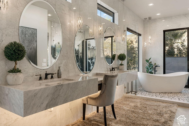 3652 South Cypress Road Hurricane, UT 84737 - Photo 42 of 81 Dual floating vanity with integrated sinks, contemporary oval mirrors, pendant lighting, freestanding soaking tub, and large format wall tile