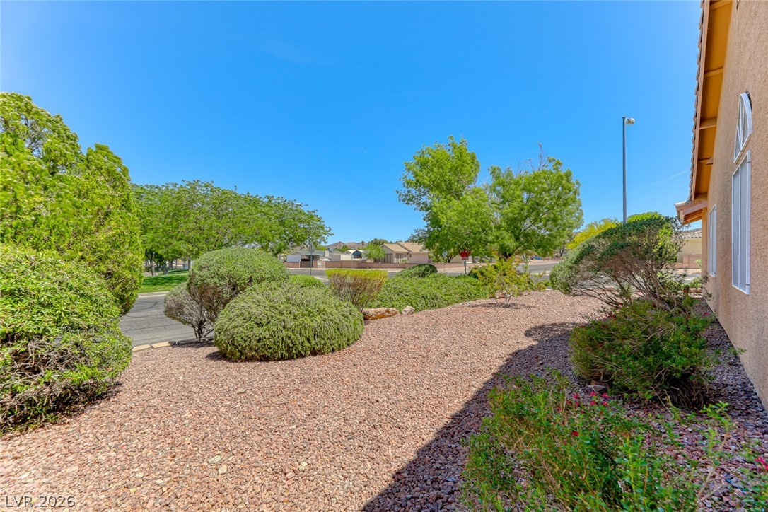 2001 Appaloosa Road Henderson, NV 89002 - Photo 9 of 44 This spacious yard features mature landscaping and a well-maintained exterior, perfect for outdoor enjoyment.