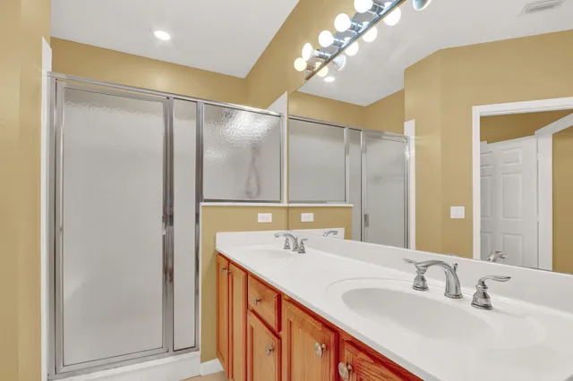 a bathroom with a double vanity sink and a mirror