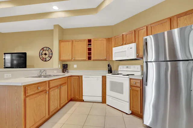 a kitchen with stainless steel appliances granite countertop a refrigerator sink and stove