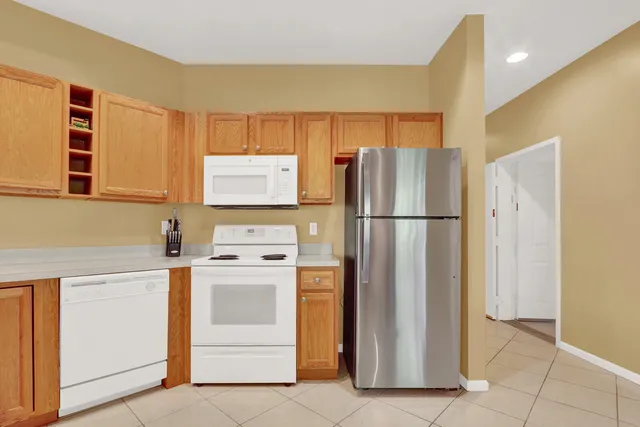 a kitchen with stainless steel appliances granite countertop a refrigerator and a stove