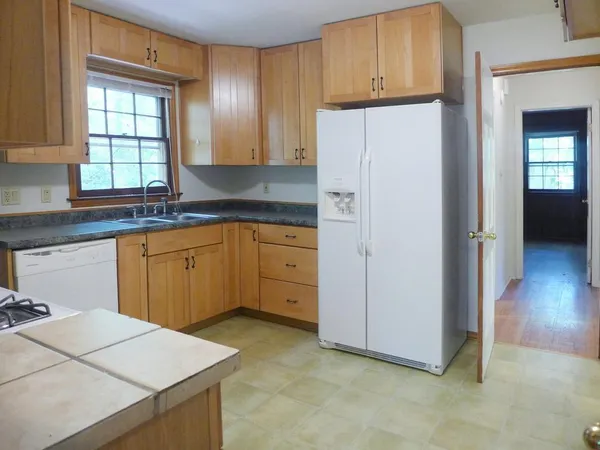 a kitchen with stainless steel appliances a refrigerator sink and cabinets