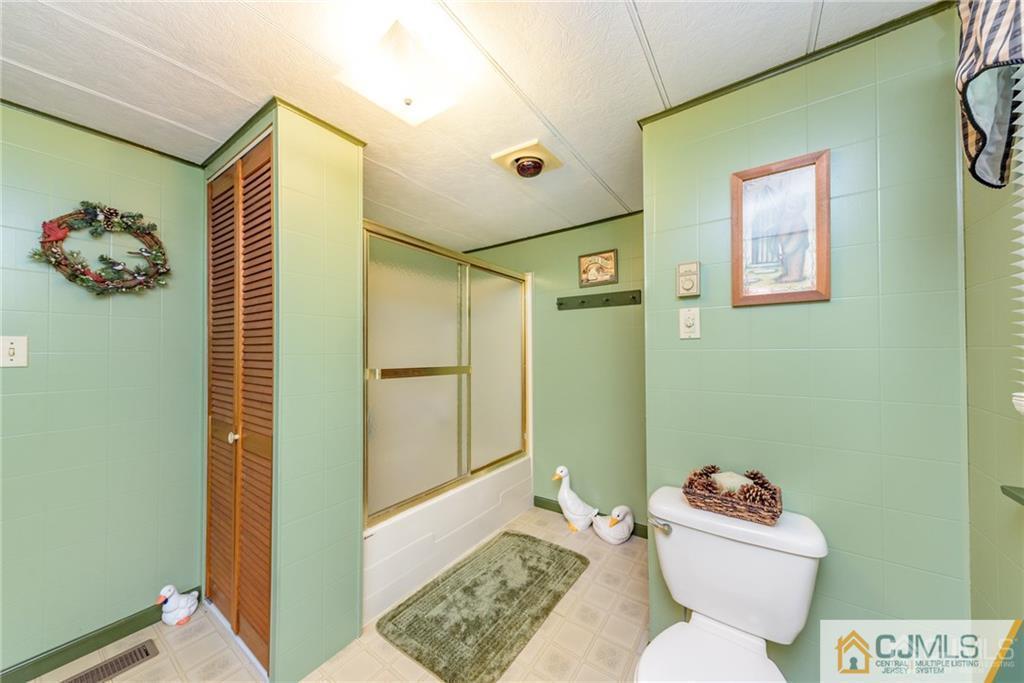 35 Warrington Road Columbia, NJ 07832 - Photo 19 of 31 a bathroom with a sink mirror vanity and toilet