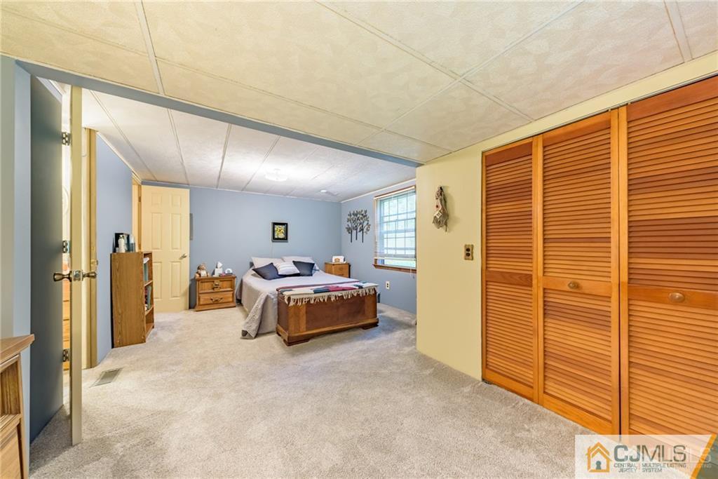 35 Warrington Road Columbia, NJ 07832 - Photo 20 of 31 a spacious bedroom with a bed and a dresser