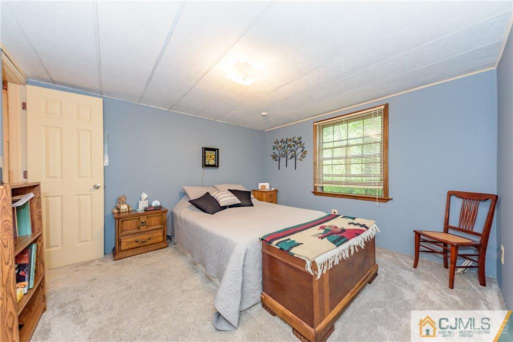 35 Warrington Road Columbia, NJ 07832 - Photo 21 of 31 a bedroom with a bed and a window