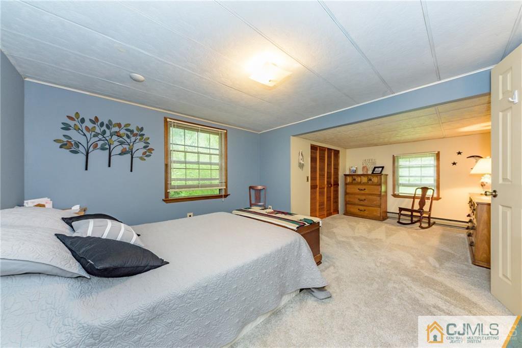 35 Warrington Road Columbia, NJ 07832 - Photo 22 of 31 a bedroom with a bed a couch and large window