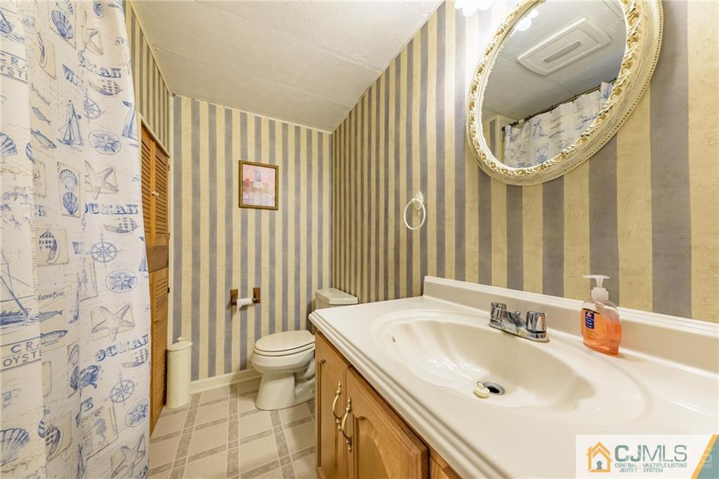 35 Warrington Road Columbia, NJ 07832 - Photo 24 of 31 a bathroom with a sink and a mirror