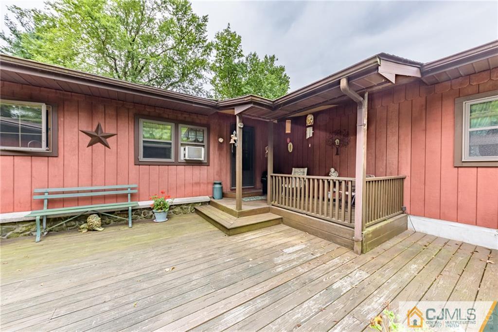 35 Warrington Road Columbia, NJ 07832 - Photo 3 of 31 a view of a deck with a table and chairs and wooden floor