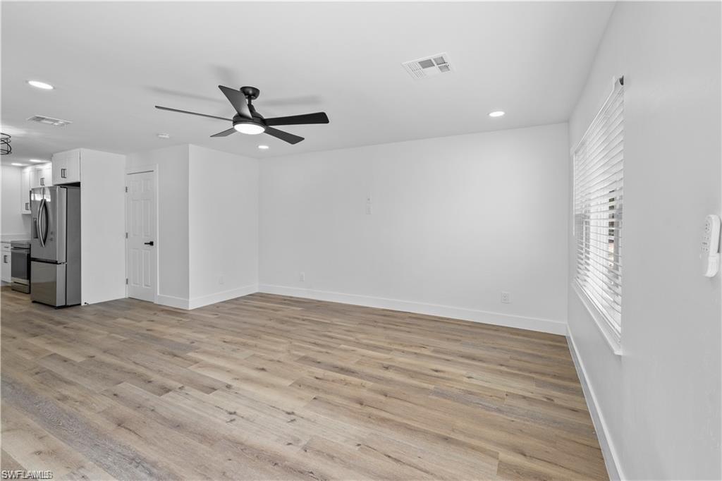 1855 Danford Street, Unit A Naples, FL 34112 - Photo 4 of 22 Unfurnished living room featuring light wood-style floors, recessed lighting, and ceiling fan