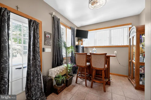 a view of a dining room with furniture and a window
