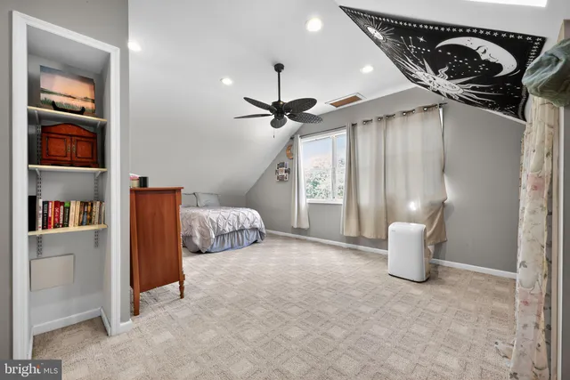 a bedroom with a bed and a book shelf