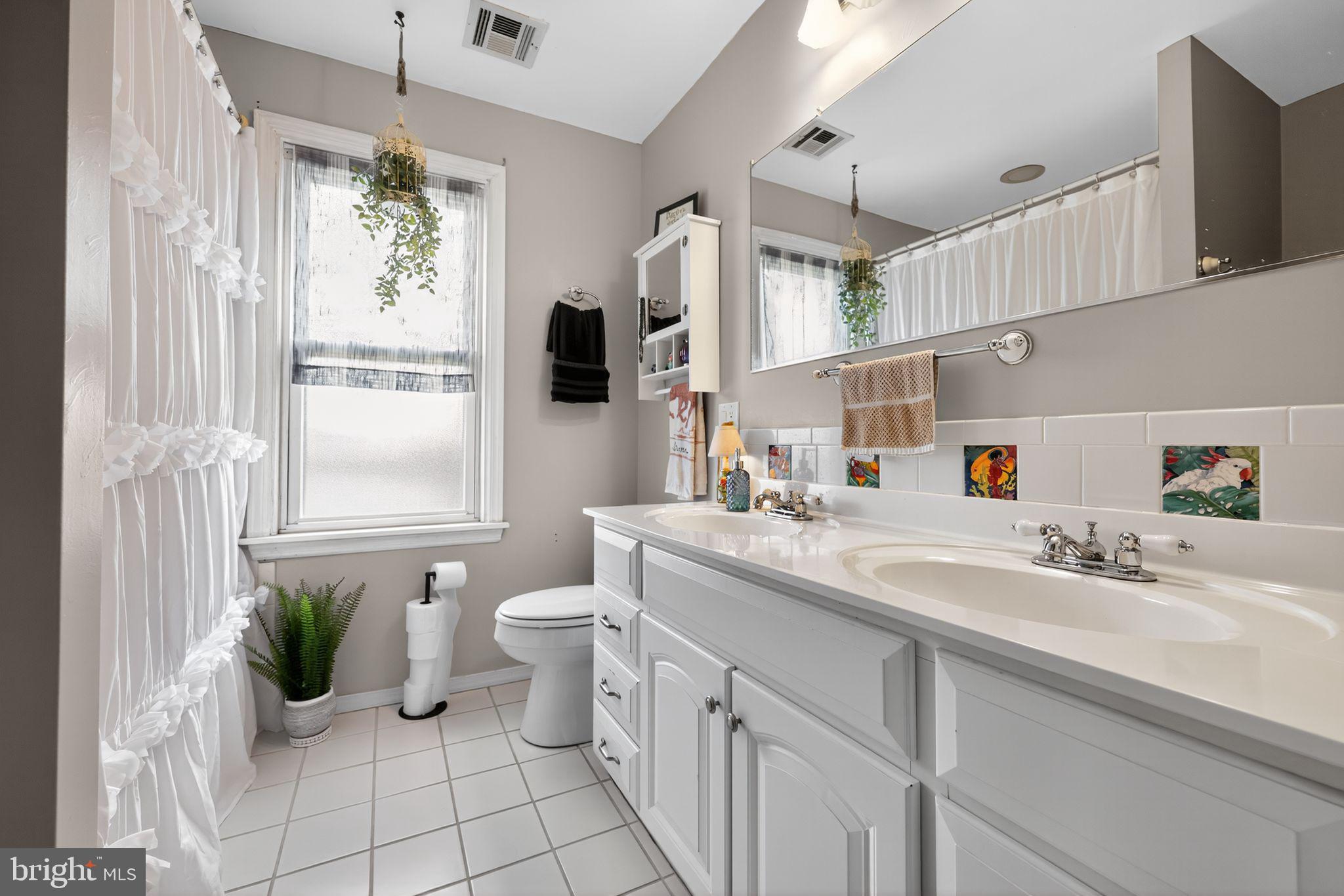 514 Park Avenue Laurel Springs, NJ 08021 - Photo 23 of 30 a bathroom with a sink mirror and a window
