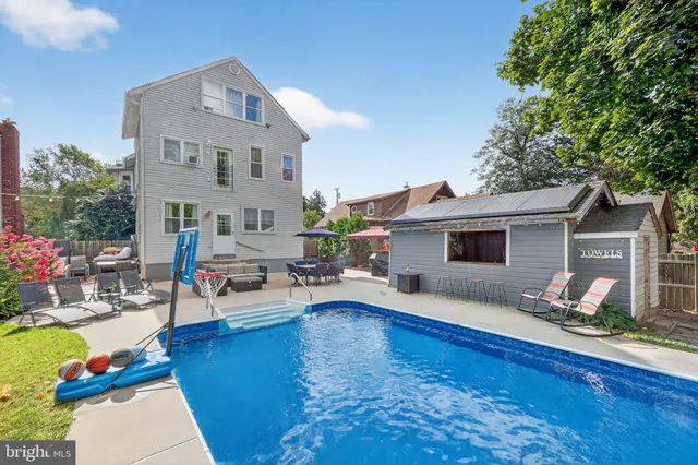 a house view with a sitting space garden and swimming pool