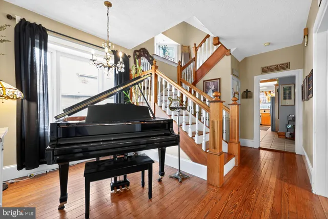 a view of entryway and hall with wooden floor