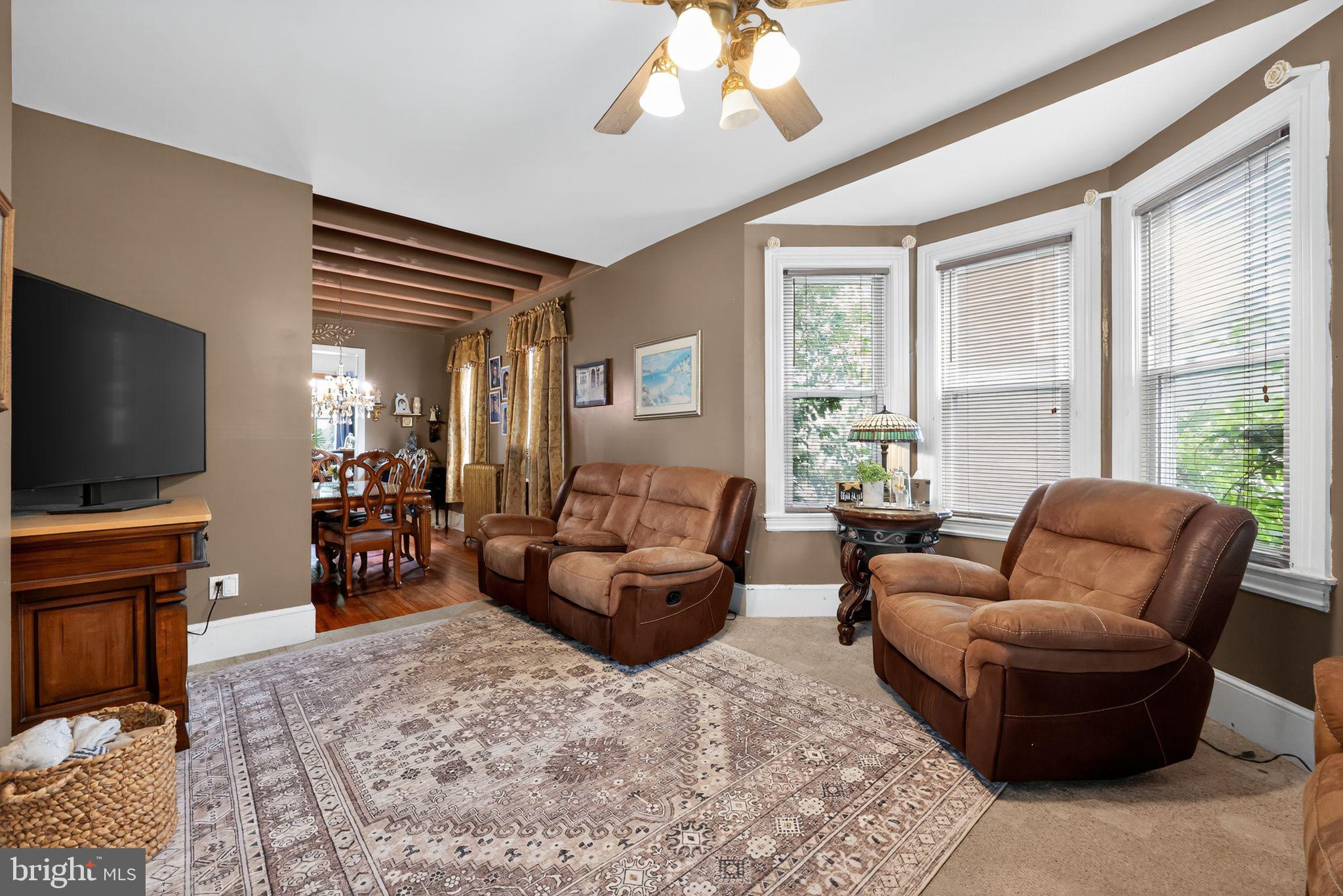 514 Park Avenue Laurel Springs, NJ 08021 - Photo 5 of 30 a living room with furniture a large window and a flat screen tv
