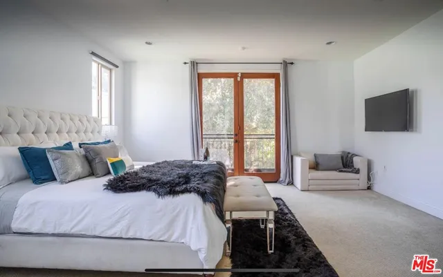 a bedroom with a bed and a couch