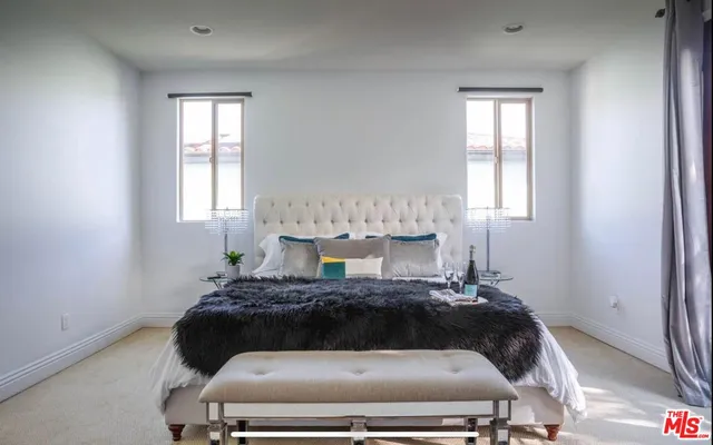 a bedroom with a bed and window