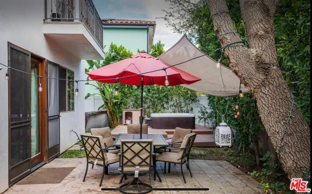 a view of an outdoor sitting area with furniture and umbrella