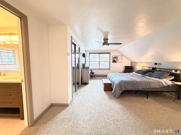a bedroom with furniture and a flat screen tv