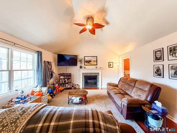 a bedroom with a bed couch and a window